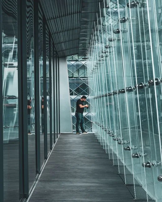 Interior office space that feels open and modern, featuring glass dividers, elegant furnishings, and colorful wall art.